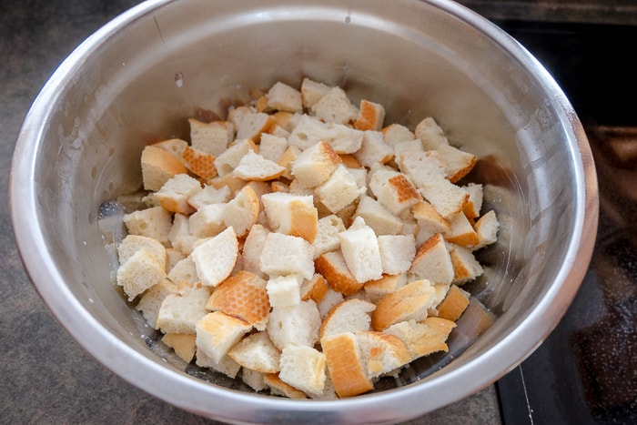 soft bread pieces on silver mixing bowl on counter