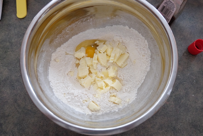 butter and eggs in metallic mixing bowl on counter