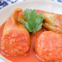 hungarian stuffed peppers in white bowl with parsley