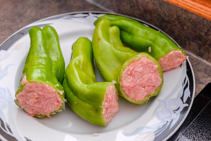 raw green hungarian stuffed peppers on plate