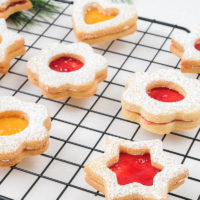 shaped linzer cookies with jam on cookie cooling tray