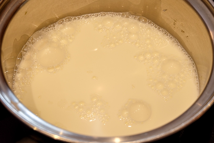 milk boiling on stovetop in pot