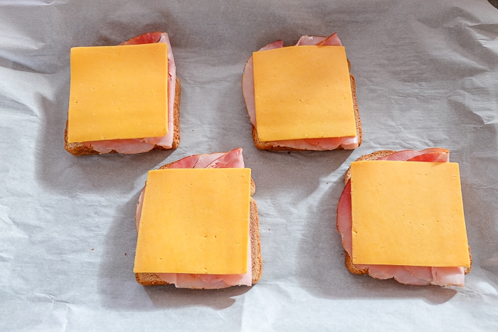 slices of cheese on toast on parchment paper