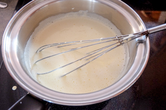 whisking pot of homemade vanilla pudding