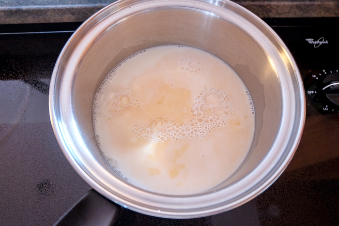vanilla extract in milk on silver pot on stove top