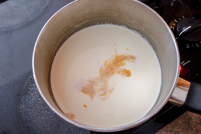 vanilla extract in milk in pot on stove