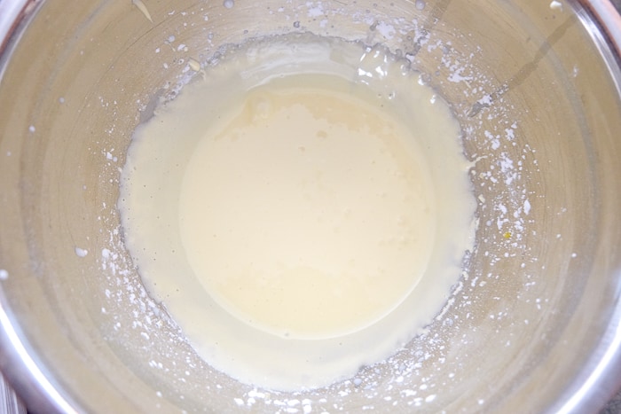 vanilla sauce mixture in silver mixing bowl