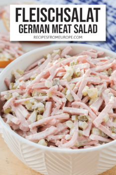 German meat salad in white bowl with text overlay saying "Fleischsalat German Meat Salad"