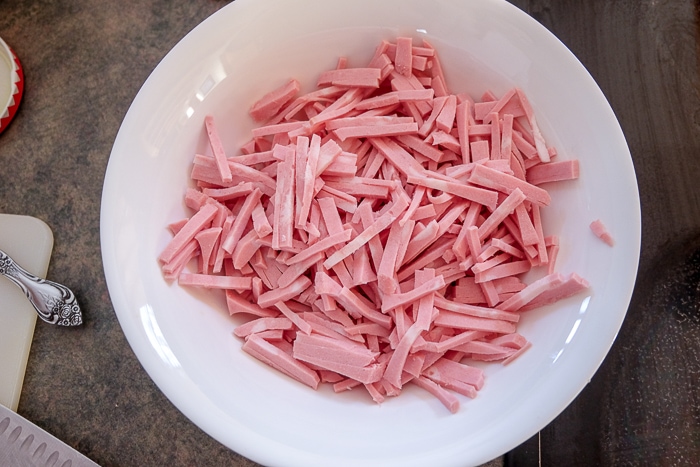 pieces of cut mortadella in white bowl on counter