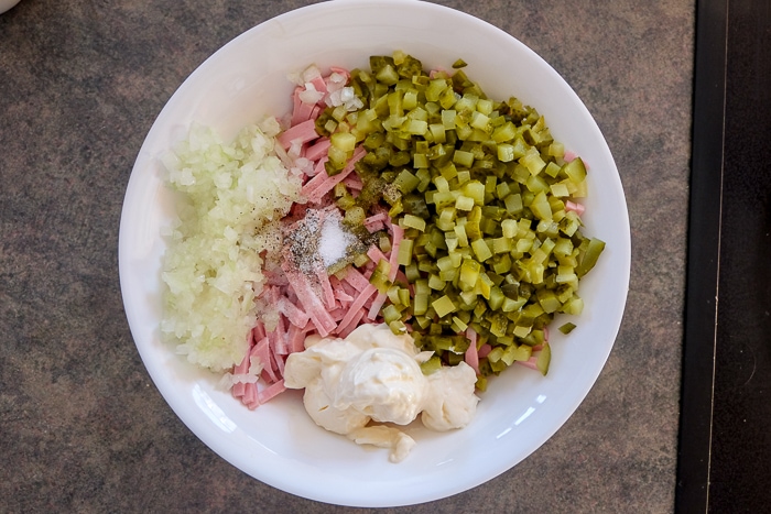 bowl of chopped meat and pickles with mayonnaise on counter 