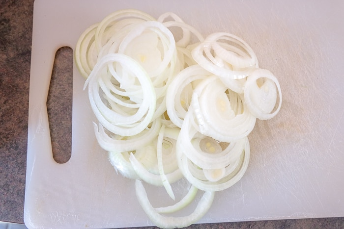 rings of fresh onions cut on cutting board