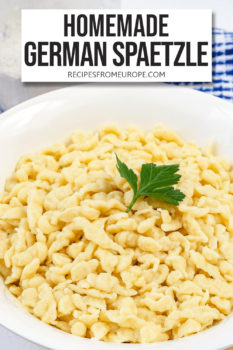 Photo of spaetzle noodles in white bowl with parsley as garnish and text overlay saying homemade German spaetzle