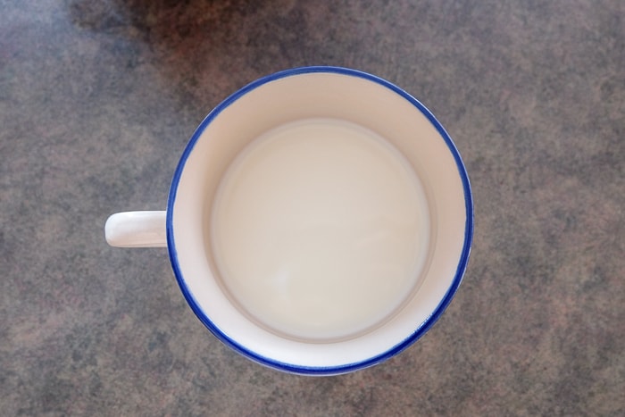 mug with blue rim of milk on counter top