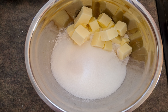chunks of butter and sugar in mixing bowl on counter