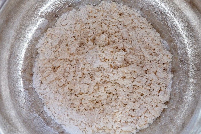 dough for crumb cake in silver mixing bowl