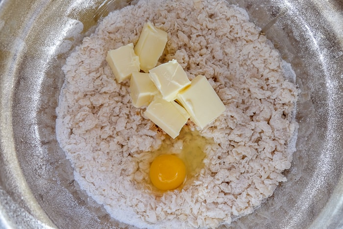 crumb cake dough with butter and egg in silver mixing bowl