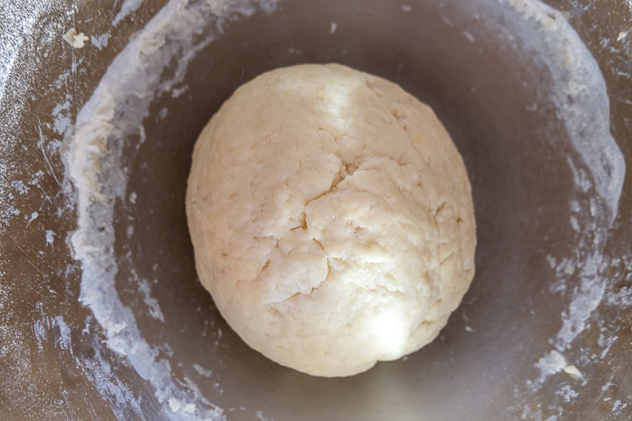 ball of dough for crumb cake in silver mixing bowl