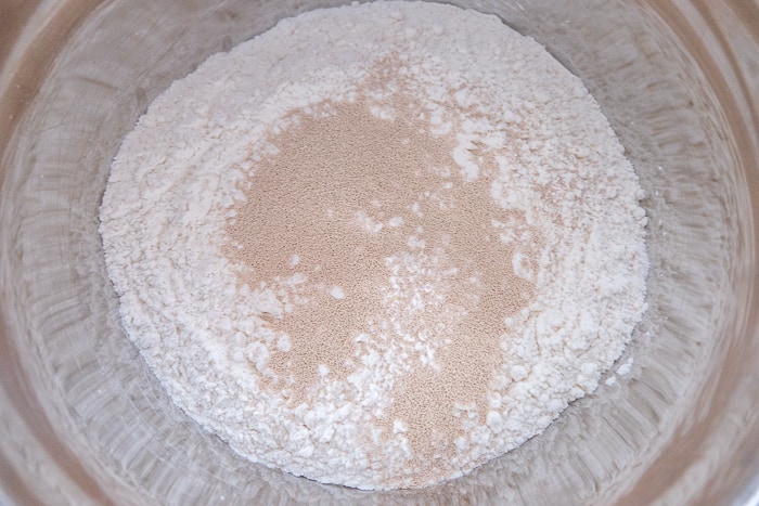 yeast on flour in silver mixing bowl