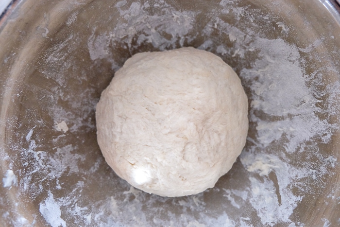 ball of brotchen dough in silver mixing bowl