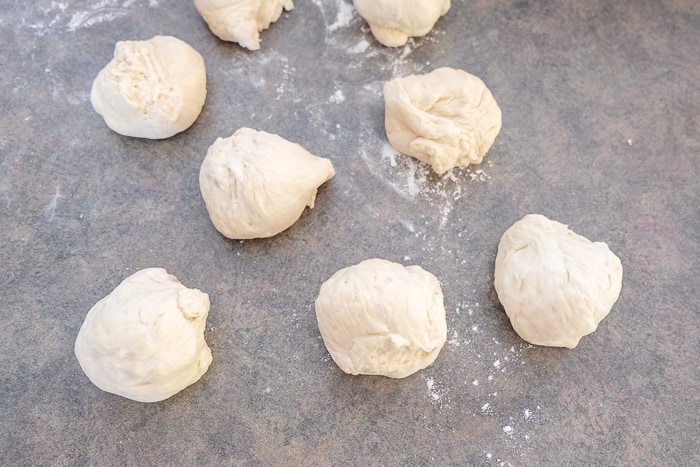 bread roll dough ripped up into small chunks on counter top