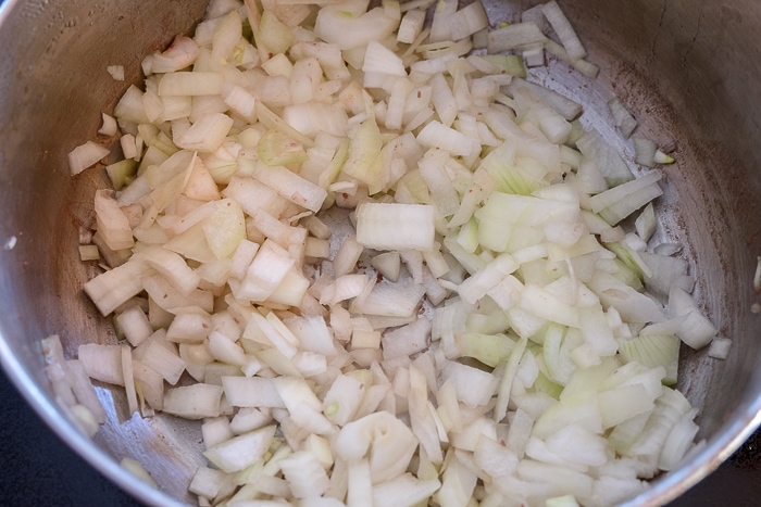 chopped onions in silver pot on stove