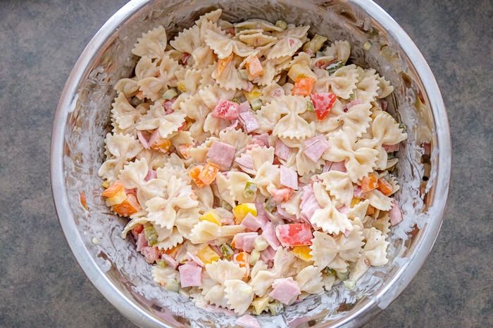mixed german pasta salad in metallic bowl on counter