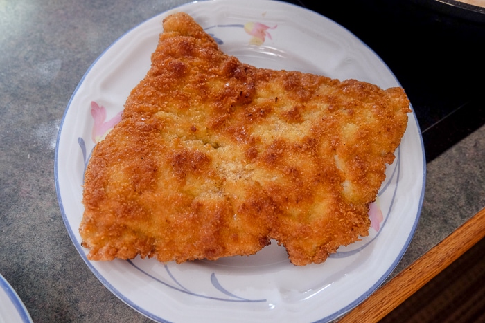 piece of cooked german schnitzel on small on counter