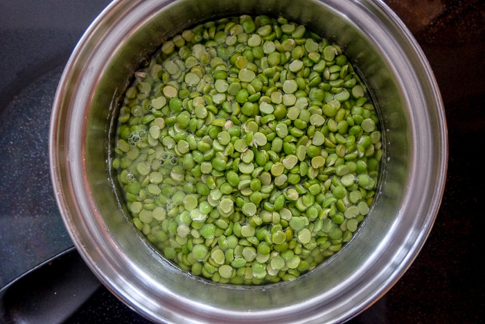 green split peas in silver pot on stove top