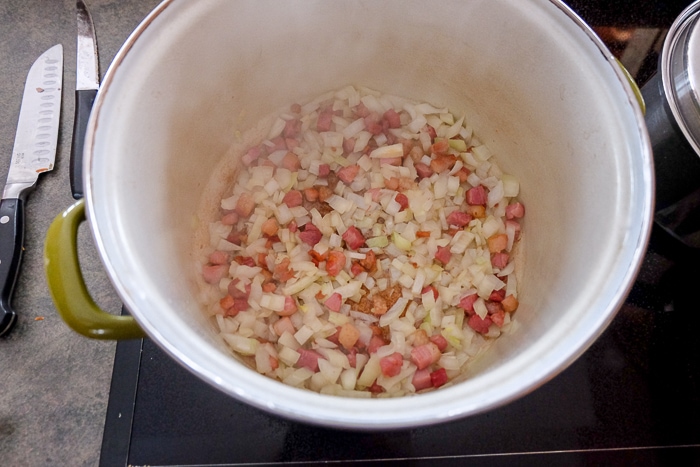 onions and pancetta frying in large soup pot