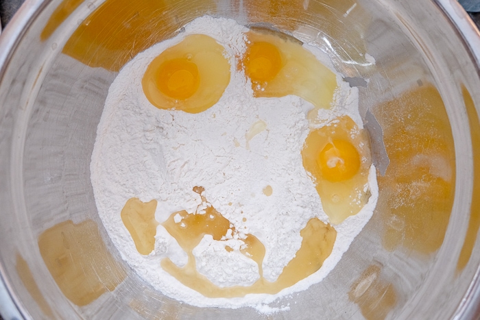 eggs and flour in metallic mixing bowl