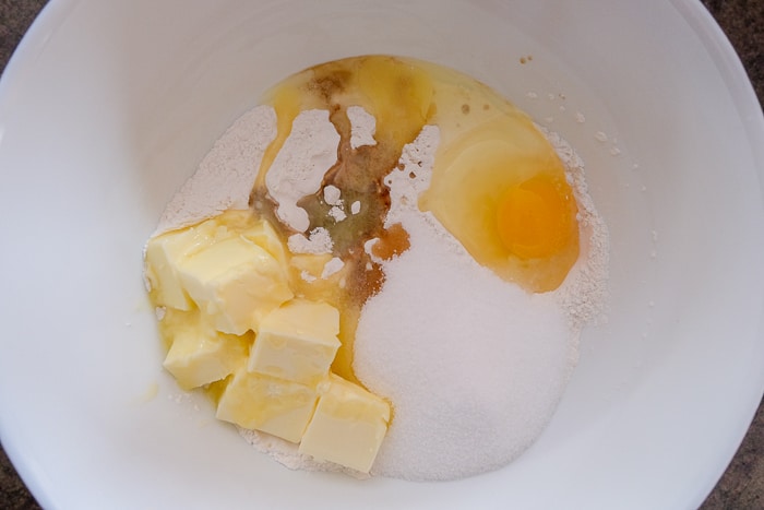 butter egg sugar and vanilla in white mixing bowl