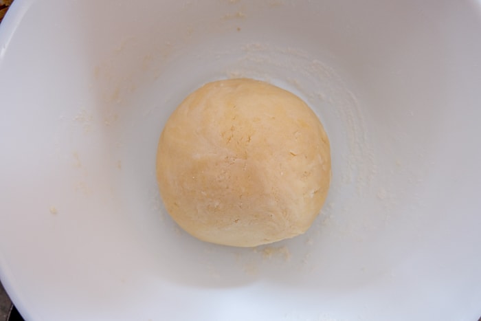 ball of dough in white mixing bowl