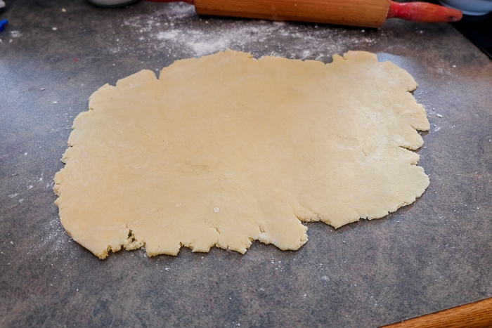 rolled out nussecken dough on counter top with rolling pin behind