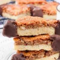 nussecken nut bars stacked on plate with more nut bars in the background