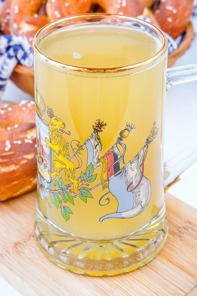 large german glass mug on wooden board with pretzels