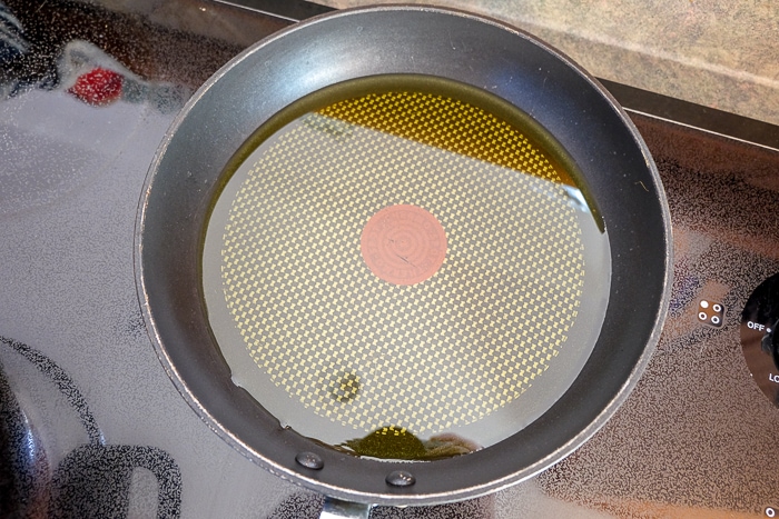 frying pan full of oil on stove top