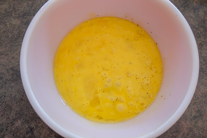 scrambled egg in small mixing bowl on counter top