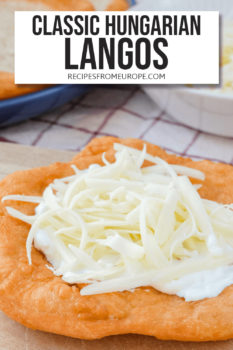 Brown fried bread with garlic sauce and shredded cheese on top and text overlay saying "classic Hungarian Langos"