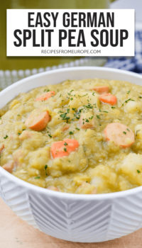 Split pea soup with pieces of sausage, carrots, potatoes and chopped parsley in white bowl with text overlay saying "easy german split pea soup"