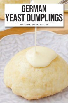 yeast dumpling on purple plate with vanilla sauce drizzled on top and text overlay saying "German yeast dumplings"