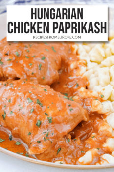 chicken thighs with red sauce on plate with yellow egg noodles and text overlay saying "Hungarian chicken paprikash"