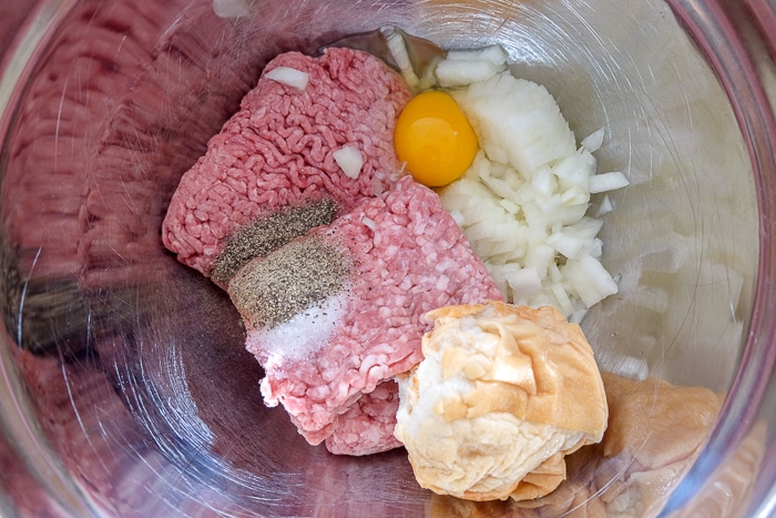 ingredients in silver mixing bowl for german meatballs