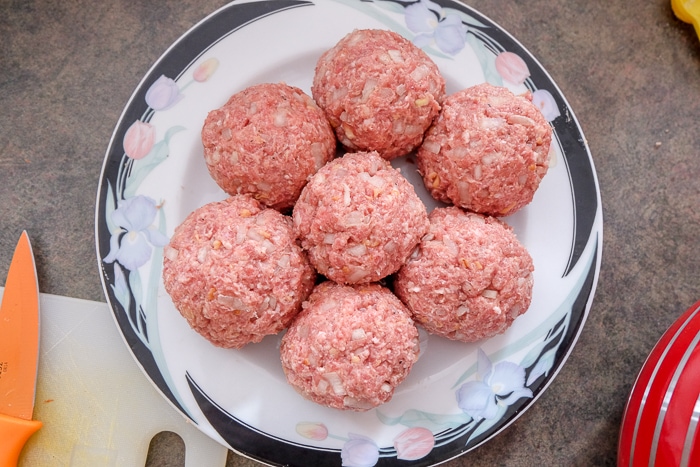raw german meatballs on plate on counter