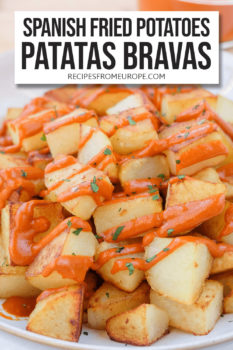 fried potato cubes in bowl with red sauce on top and text overlay saying "Spanish fried potatoes patatas bravas"