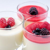 glasses of bavarian cream dessert with berries on top
