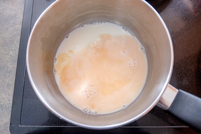 milk and vanilla in silver pot on stove top