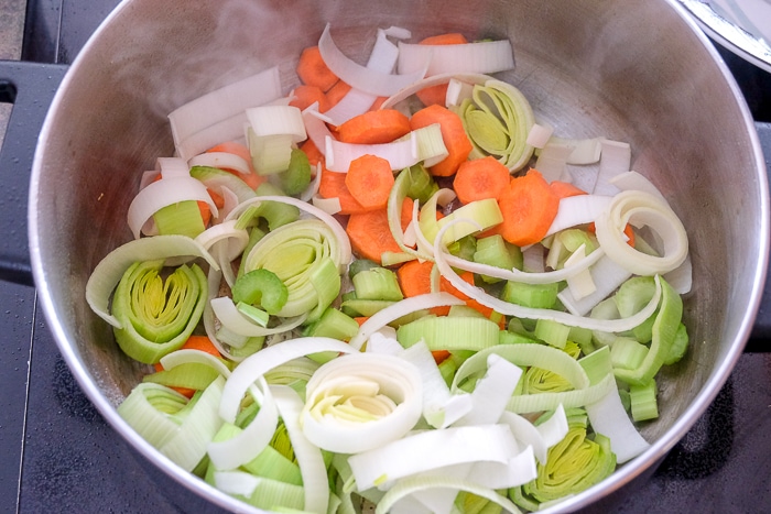 chopped vegetables in large pot on stove top