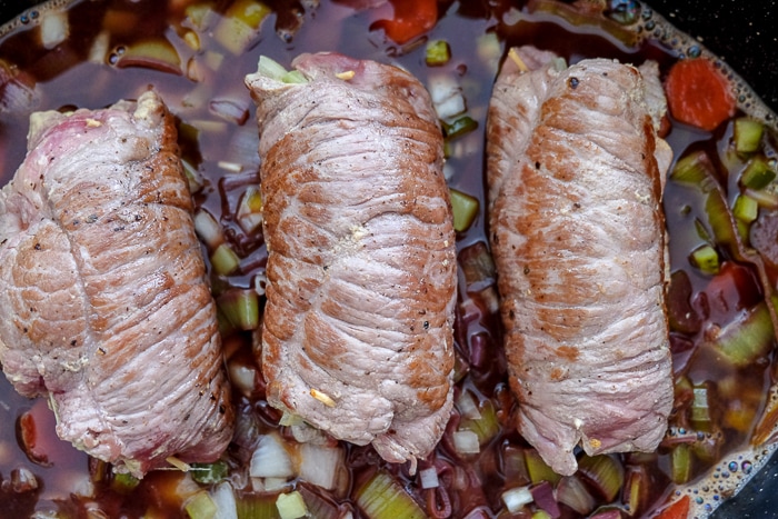 seared beef rouladen on bed of vegetables