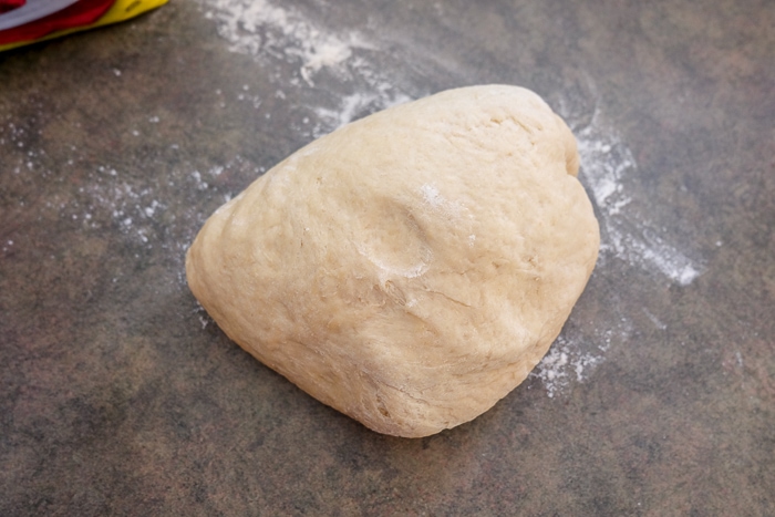 hefezopf bread dough on counter top with flour around