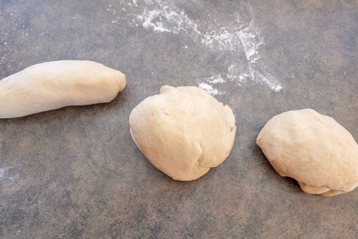 three pieces of german sweet bread dough sitting on counter top